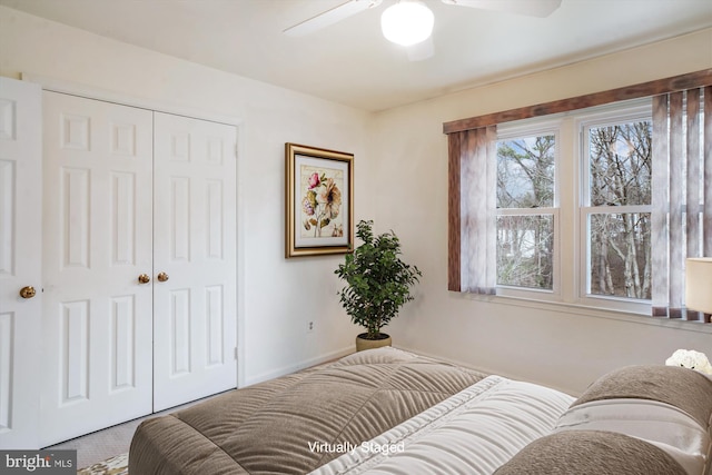 bedroom with ceiling fan and a closet