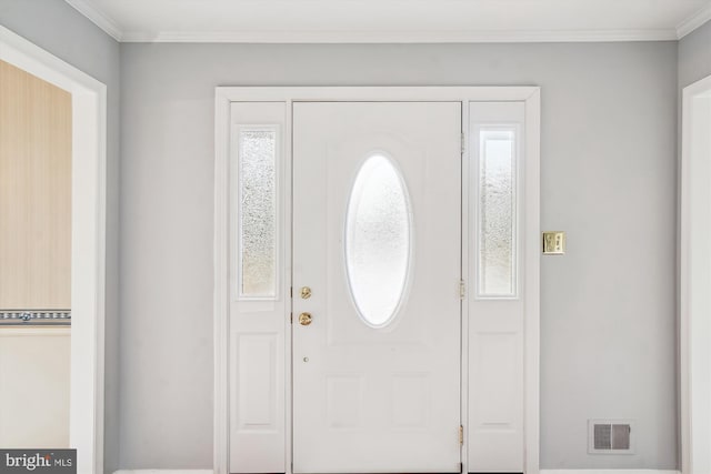 entrance foyer featuring plenty of natural light and ornamental molding