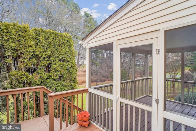 wooden deck featuring a sunroom