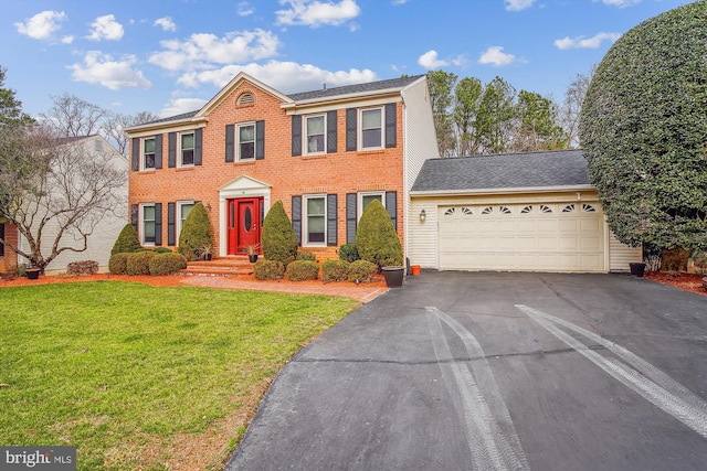 view of front of property featuring a garage and a front yard