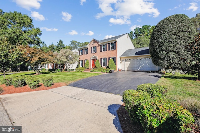 colonial-style house with a front lawn and a garage