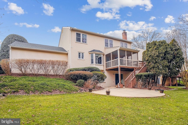 back of property with a patio, a lawn, and a sunroom