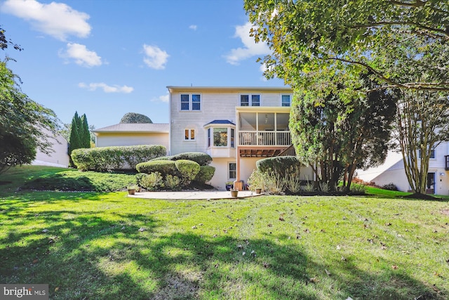 view of front of home with a front lawn and a sunroom