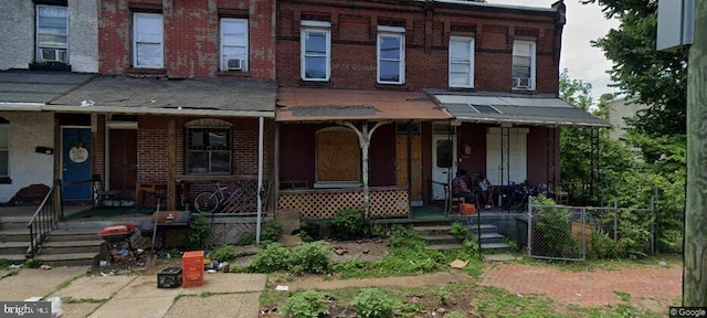 view of property with cooling unit and a porch