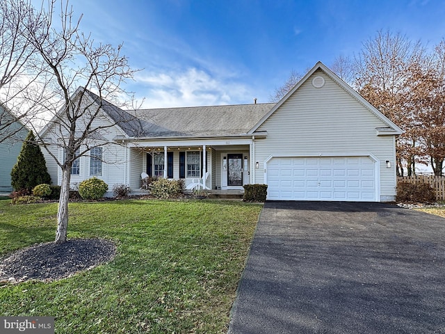 ranch-style home featuring covered porch, a garage, and a front lawn