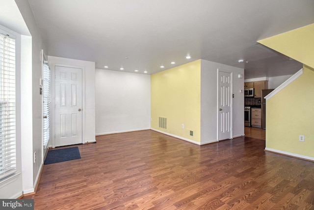 unfurnished room featuring dark hardwood / wood-style flooring