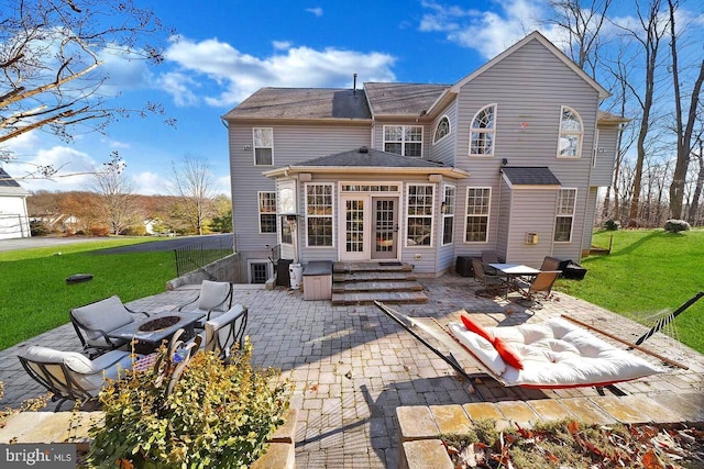 back of property with a lawn and a patio area