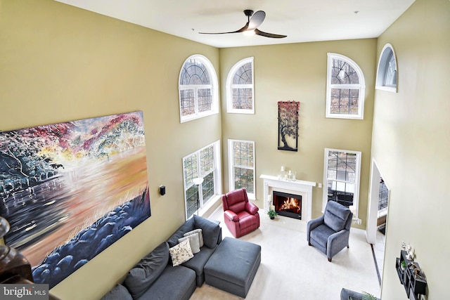 living room with ceiling fan and light colored carpet