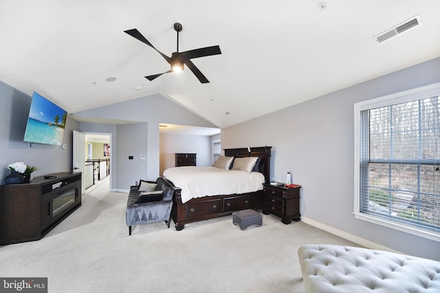 carpeted bedroom featuring ceiling fan, lofted ceiling, and multiple windows