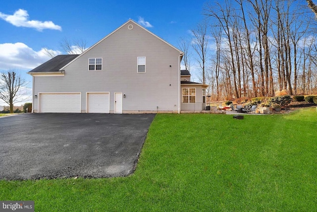 view of side of home featuring a yard and a garage