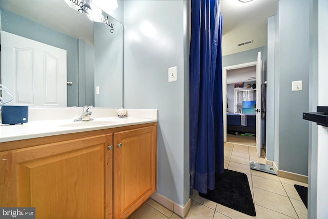 bathroom with tile patterned flooring and vanity