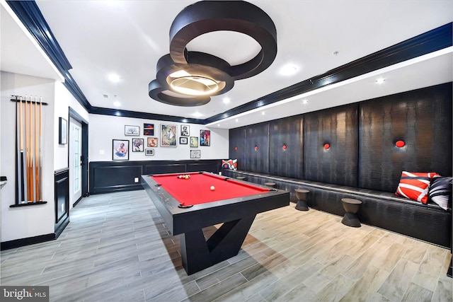 recreation room with a tray ceiling, crown molding, and billiards