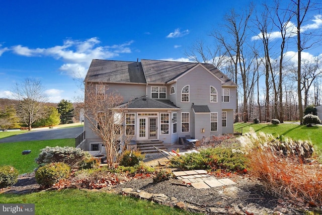 rear view of property with a lawn