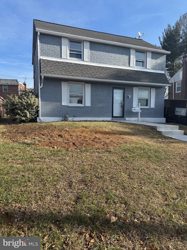 view of property featuring a front lawn