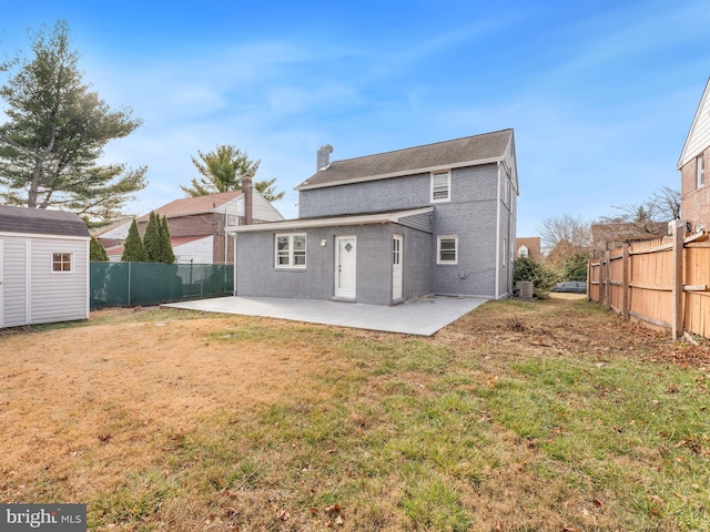 back of property featuring a yard and a patio