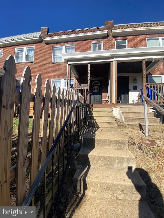 back of property with covered porch