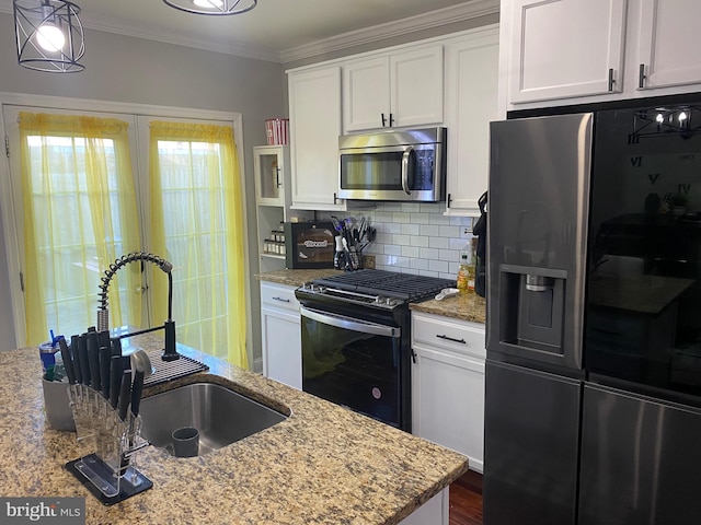 kitchen with white cabinets, sink, decorative backsplash, light stone countertops, and appliances with stainless steel finishes