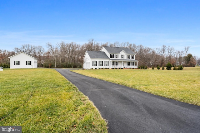 cape cod home featuring a front yard