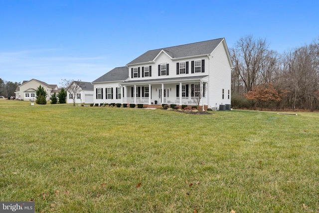 view of front facade with central AC, a porch, and a front yard