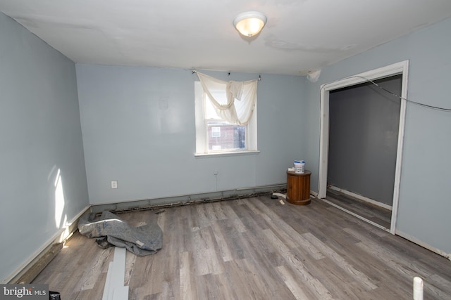 unfurnished bedroom featuring light wood-type flooring and a closet