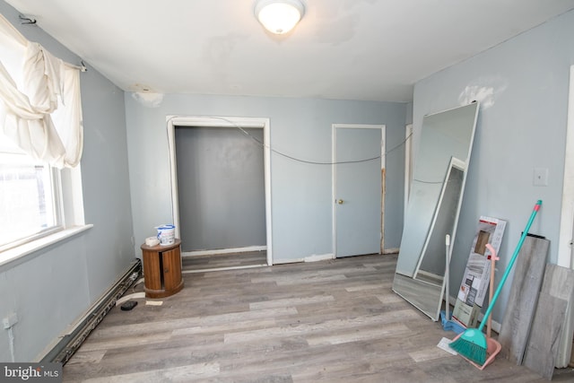 bedroom with light wood-type flooring and a closet