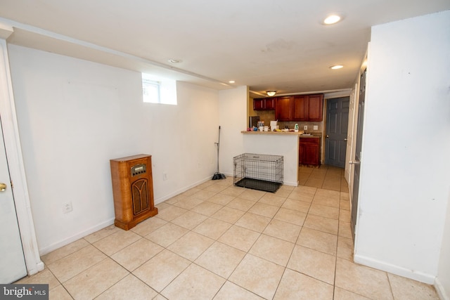 kitchen featuring light tile patterned floors and kitchen peninsula