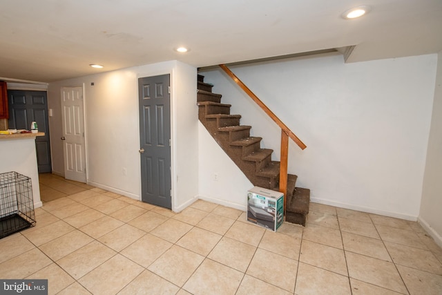 basement featuring light tile patterned floors