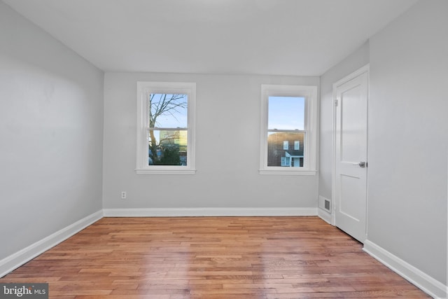 unfurnished room featuring plenty of natural light and light wood-type flooring