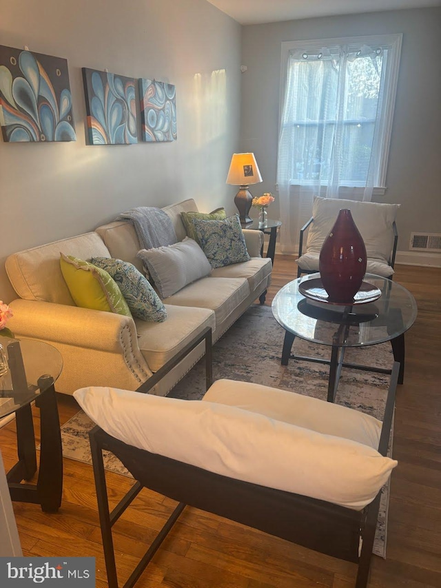 4807 Cordelia Ave, Baltimore, MD 21215 - living room featuring wood finished floors, visible vents, and baseboards