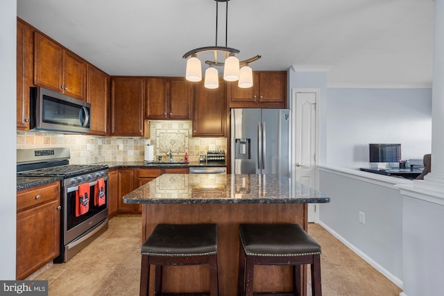 kitchen with a breakfast bar, hanging light fixtures, stainless steel appliances, decorative backsplash, and dark stone counters