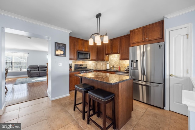 kitchen with pendant lighting, stainless steel appliances, backsplash, and light tile patterned floors