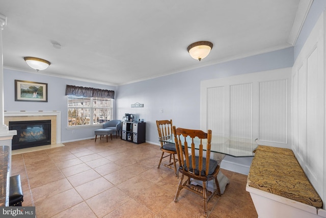 tiled dining room featuring ornamental molding