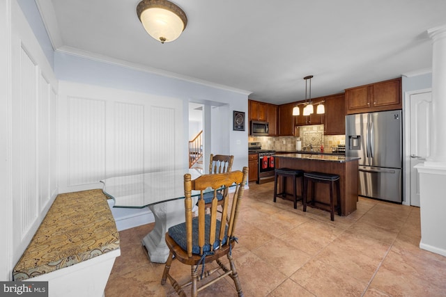 tiled dining space with sink and ornamental molding