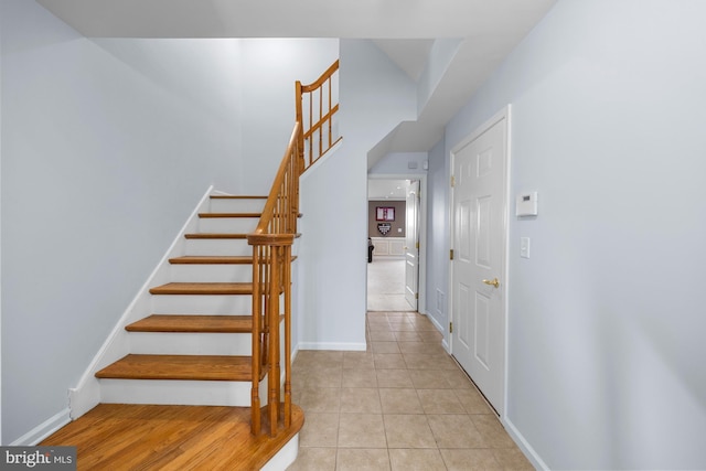 stairway with tile patterned floors