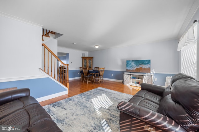 living room featuring crown molding and wood-type flooring