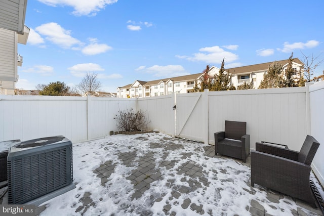 yard layered in snow featuring cooling unit