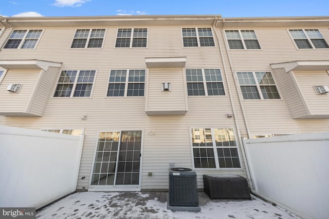 snow covered property with cooling unit