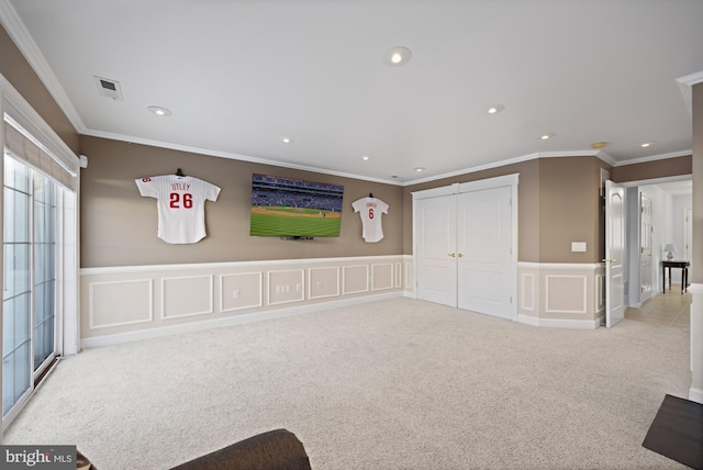 interior space with crown molding and light colored carpet