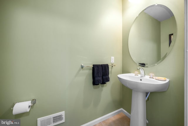 bathroom featuring tile patterned flooring and sink