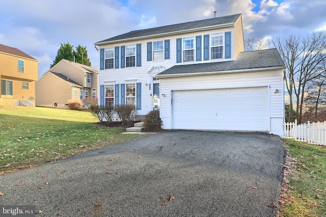 view of front facade with a garage and a front yard