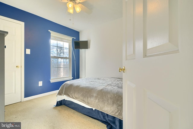 bedroom featuring light colored carpet and ceiling fan