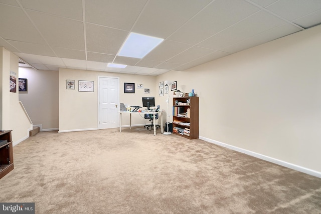 carpeted home office with a drop ceiling