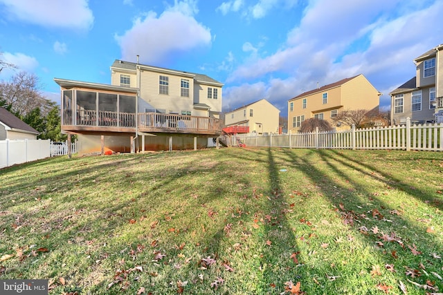 view of yard featuring a deck and a sunroom