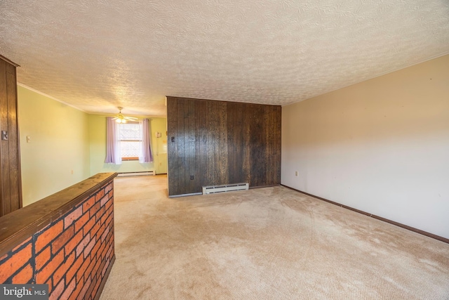 unfurnished room with baseboard heating, light carpet, and a textured ceiling