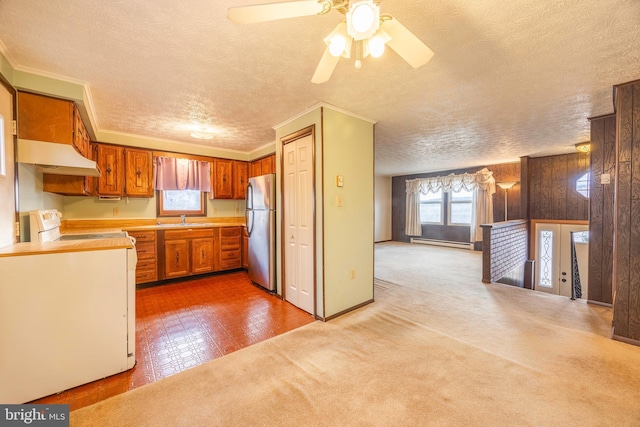 kitchen featuring white electric range, a baseboard heating unit, stainless steel fridge, wood walls, and ornamental molding