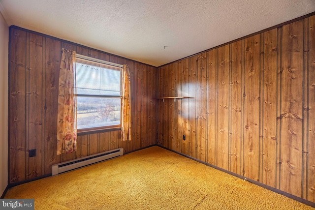 empty room featuring carpet, a textured ceiling, wooden walls, and a baseboard radiator