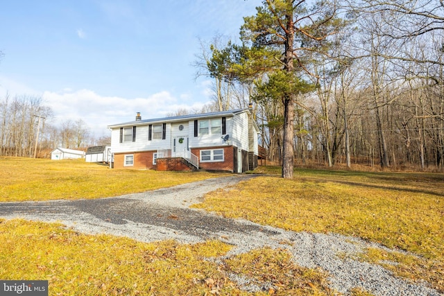 raised ranch featuring a front lawn