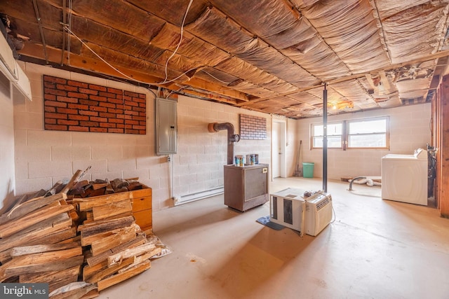 basement featuring electric panel, washer / clothes dryer, and a baseboard heating unit