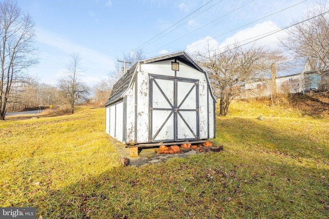 view of outbuilding featuring a yard