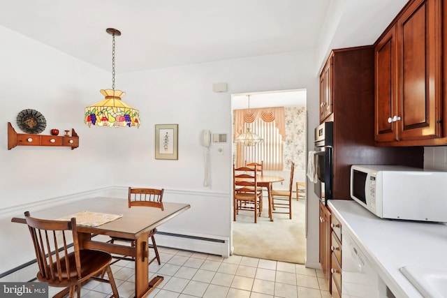 dining space featuring light tile patterned floors and a baseboard radiator